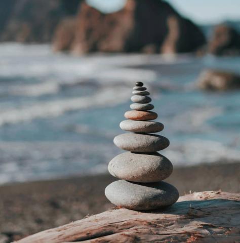 Stacked pebble stones in pyramid shape.